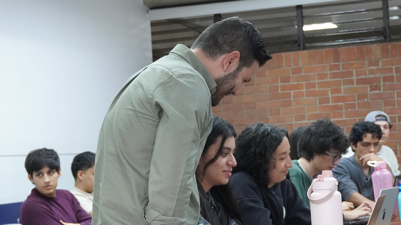 Ángel Molina resolviendo dudas con los portátiles de los asistentes en un taller práctico de inteligencia artificial en la Universidad del Valle de Guatemala